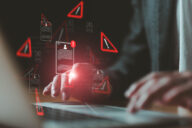 data breach, man typing on pc